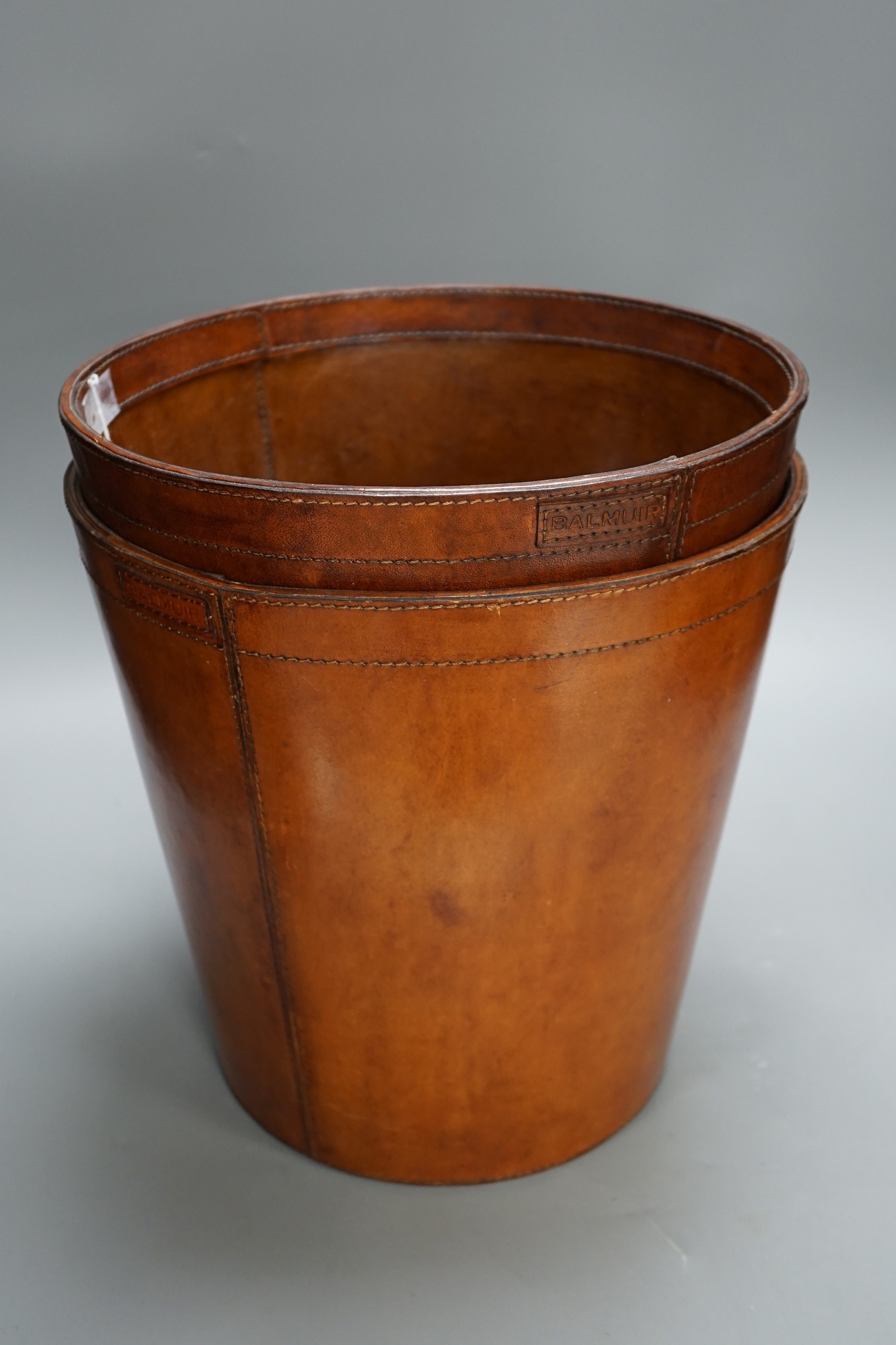 Two leather waste paper bins, 30cms high